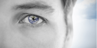 Close-up of a man's face with a globe reflected in his eye, symbolizing brain health awareness